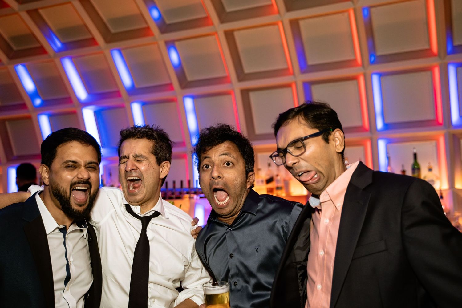 A Washington DC groom makes silly faces with his family and friends for a picture at his Hotel Washington wedding reception