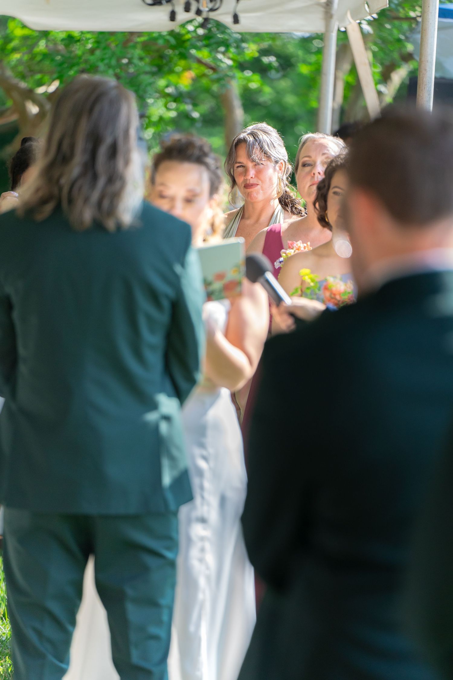 A bridesmaid looks on with pride as the bride reads her vows to the groom at a wedding ceremony in Church Hill Richmond Virginia