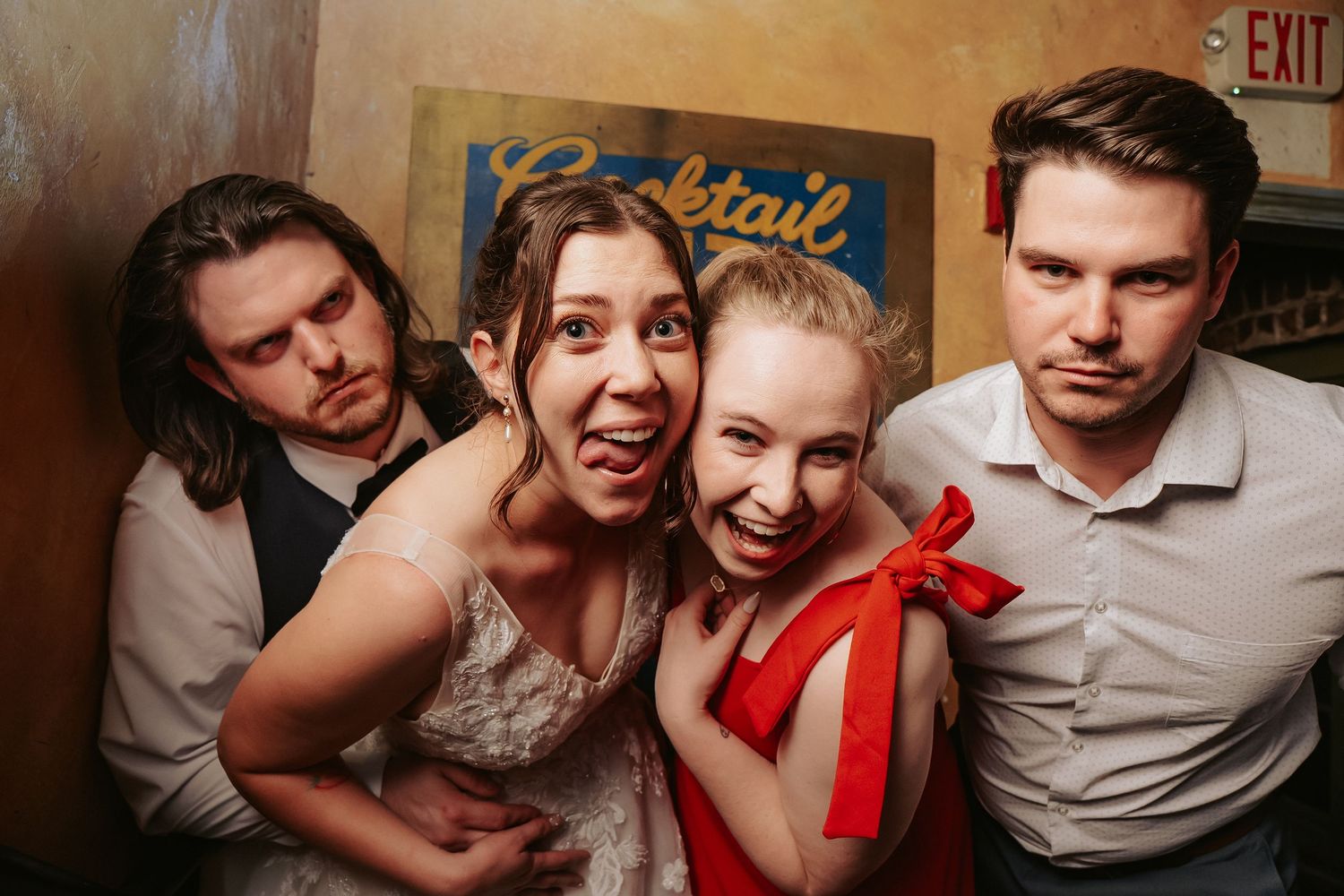 Two wedding guests pose and make silly faces with the bride and groom at the Richmond Virginia venue Havana 59