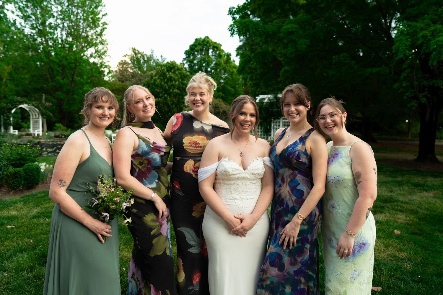 Richmond bride poses with bridesmaids and groomsmen's partners who play Dungeons and Dragons during wedding at Lewis Ginter Botanical Garden