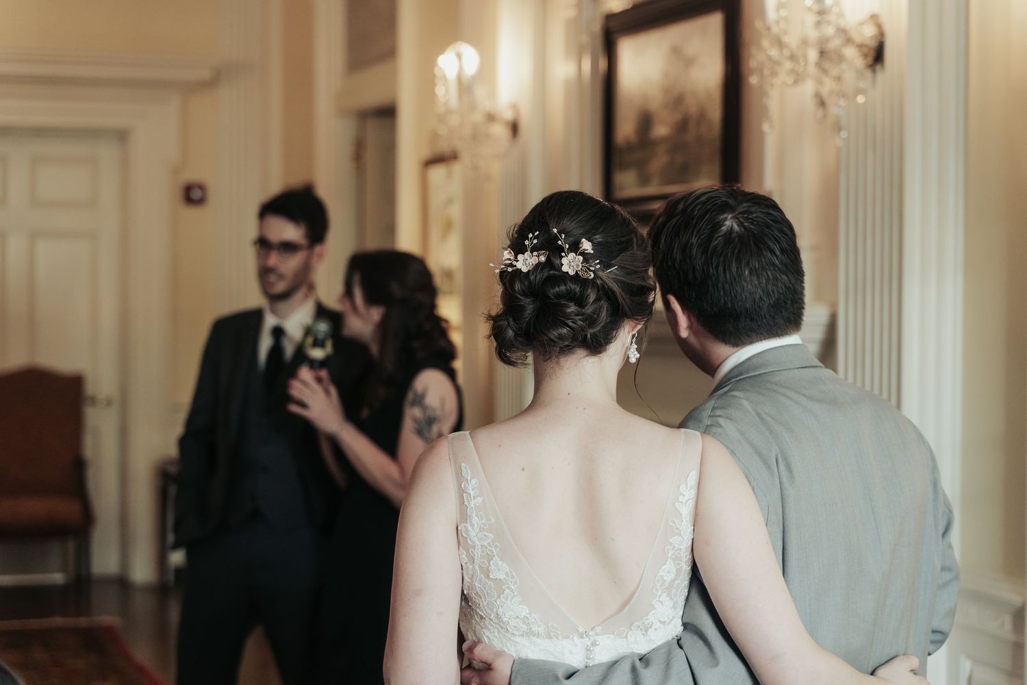 Bride and groom watch as the bride's two siblings deliver a toast at their wedding at the Virginia Museum of Fine Arts