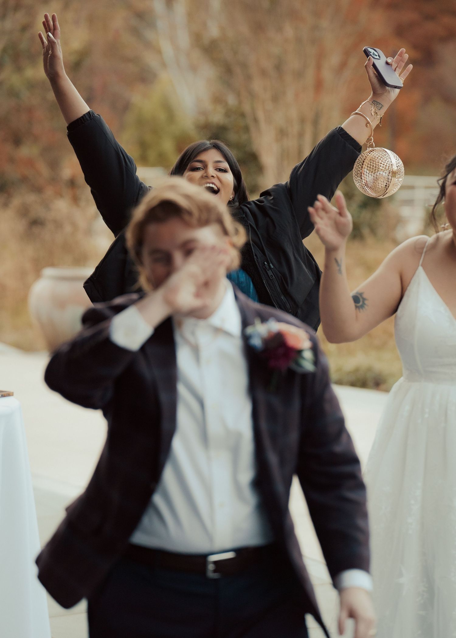LGBTQ newlywed is pranked on their wedding day by a member of their party during cocktail hour in documentary style by Maine Photographer.