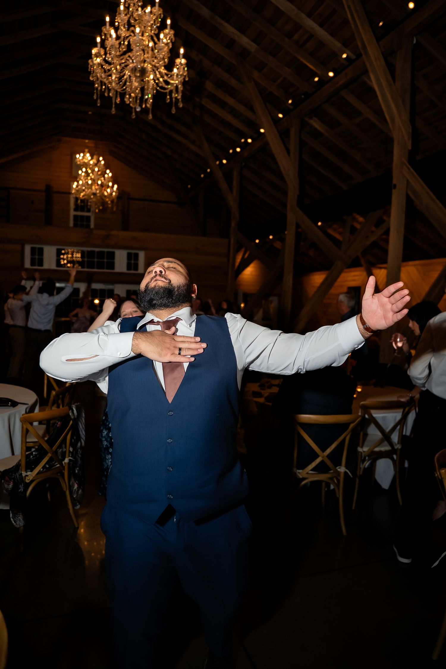 Groomsmen sings to the ceiling on the dancefloor of a Shenandoah Valley Virginia