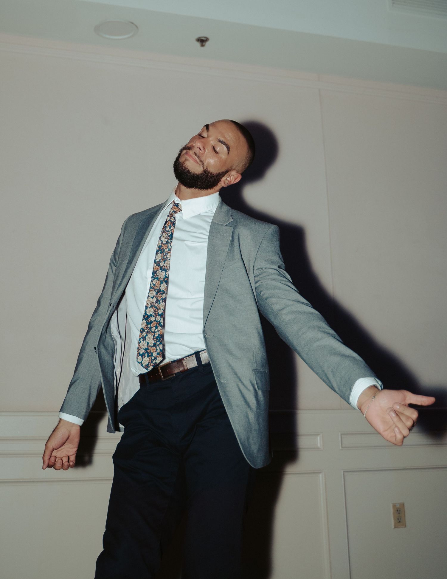 A dancing wedding guest is framed by his shadow during the reception of a gay wedding in Maryland