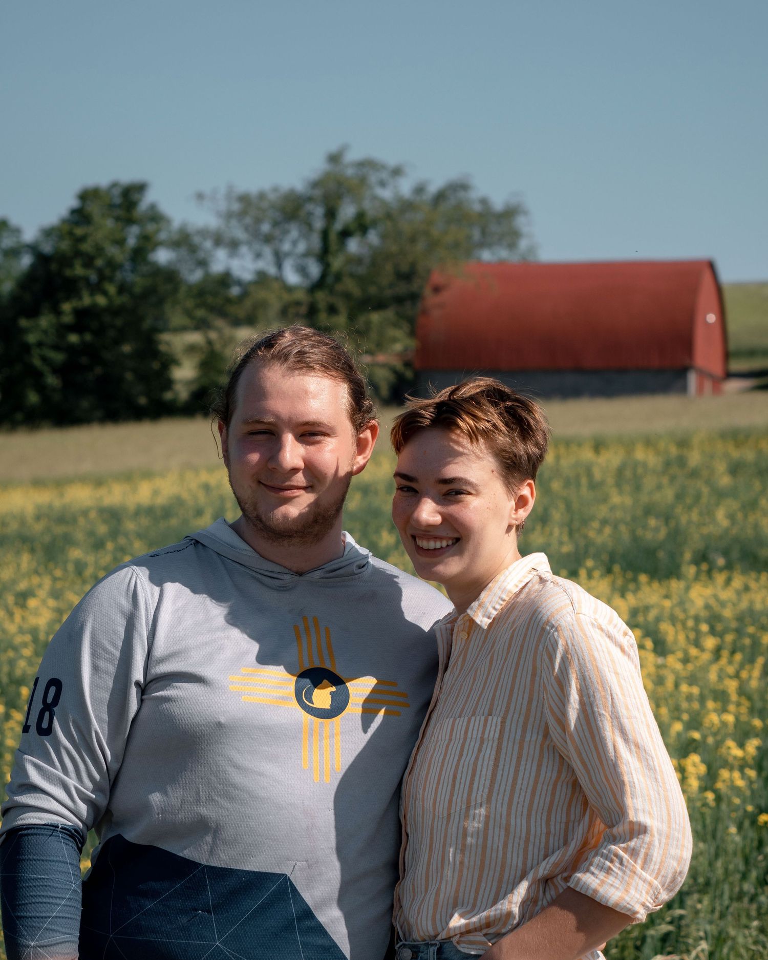 LGBTQIA New England-based wedding and event photographer Daniel Bowler and his queer, non-binary partner in farm photos