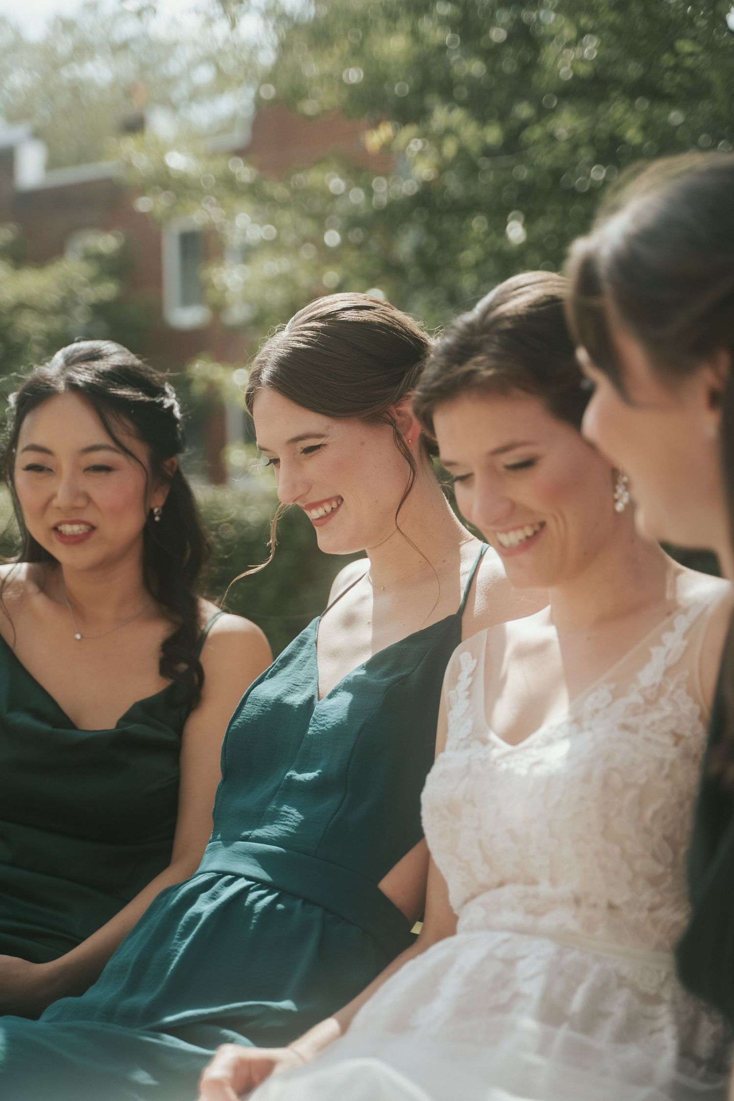 Sister of the bride smiles next to the bride and her bridesmaids while they wait for the ceremony at the Virginia Museum of Fine Arts