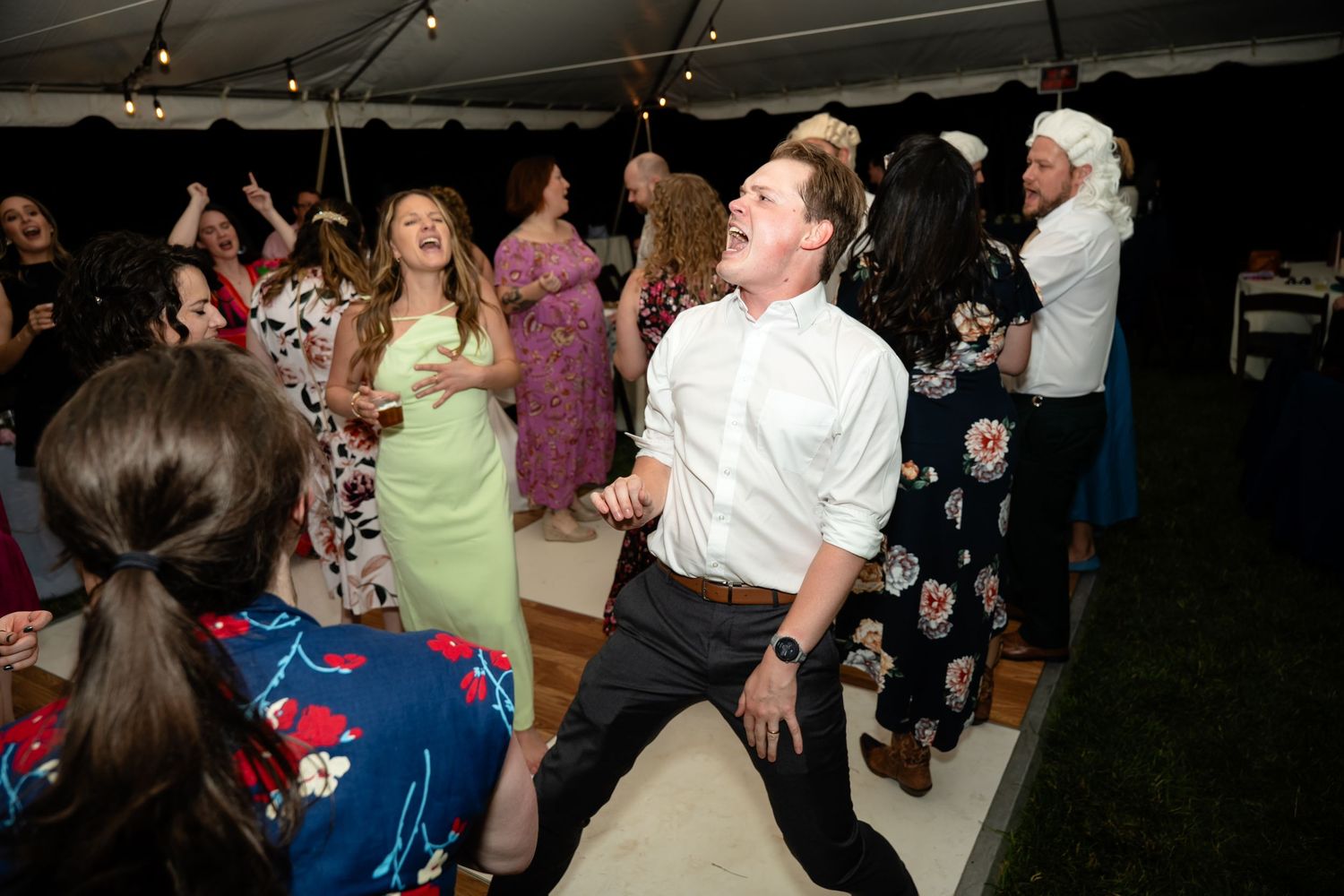 Wedding guests shout the words to a song on the dancefloor of a wedding in Richmond Virginia