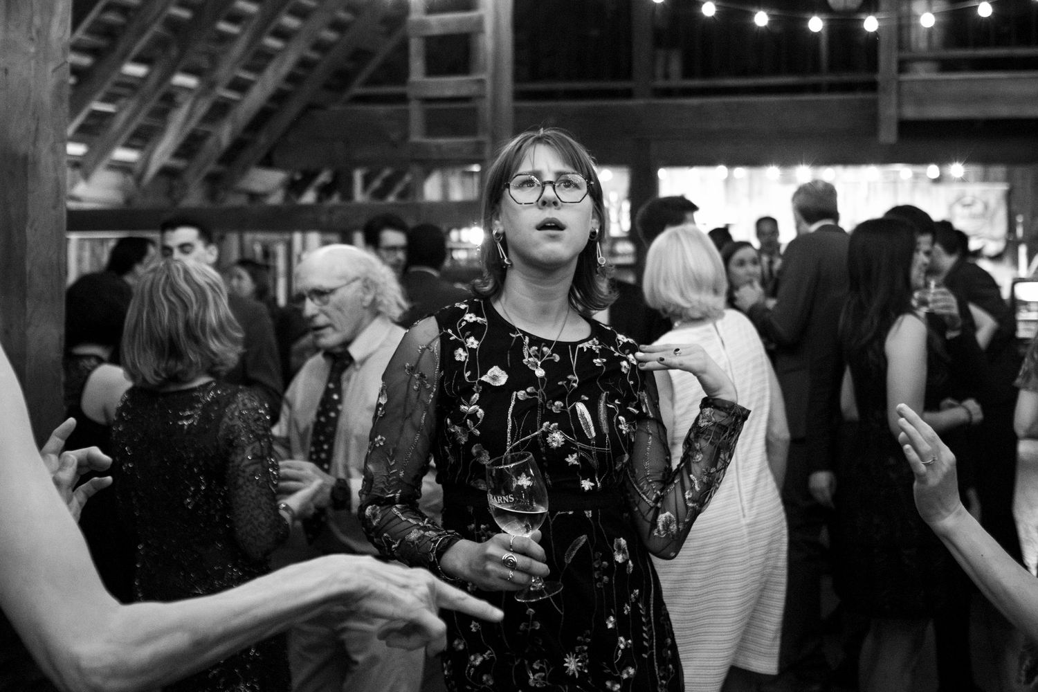 Wedding guest poses for the camera on the dancefloor in black and white shot at Northern Virginia wedding