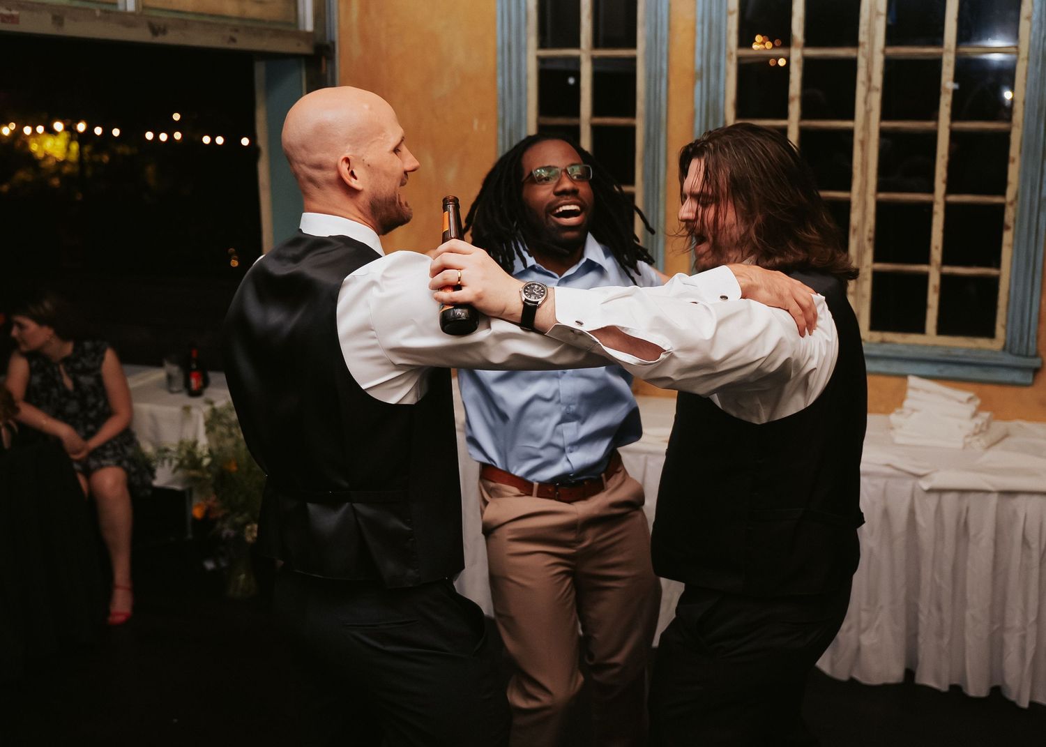 A Richmond Virginia Groom spins on the dancefloor with two friends during their reception at Havana 59