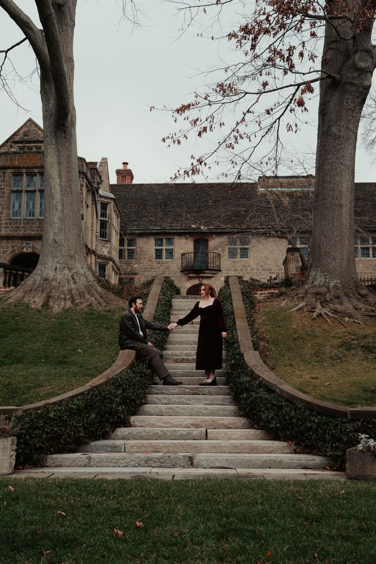 Engagement photos on a stairwell in the historic Virginia House museum for an academic fantasy engagement photo session