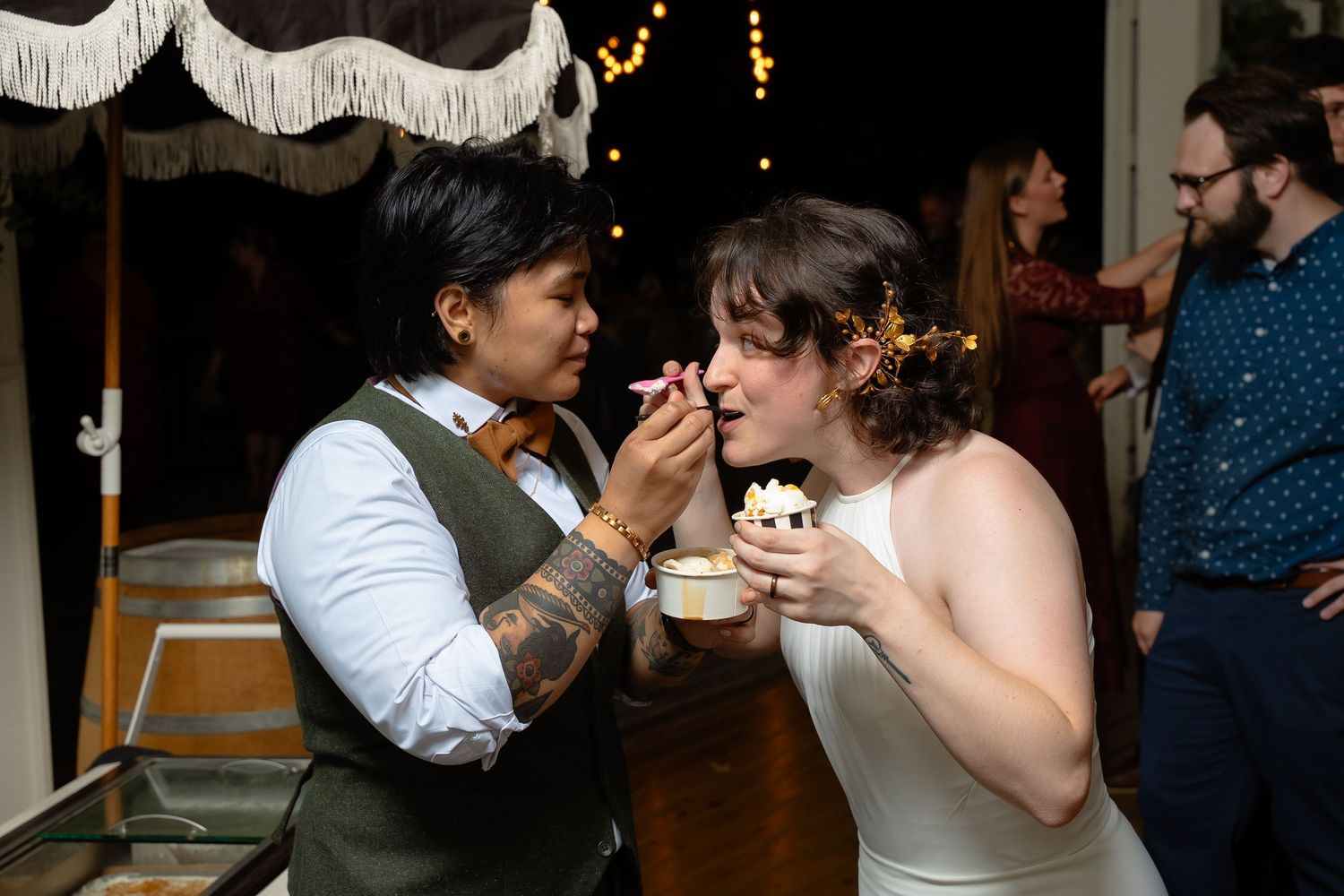 Blue ridge mountain brides share scoops of gelato at their wedding in the Shenandoah mountains