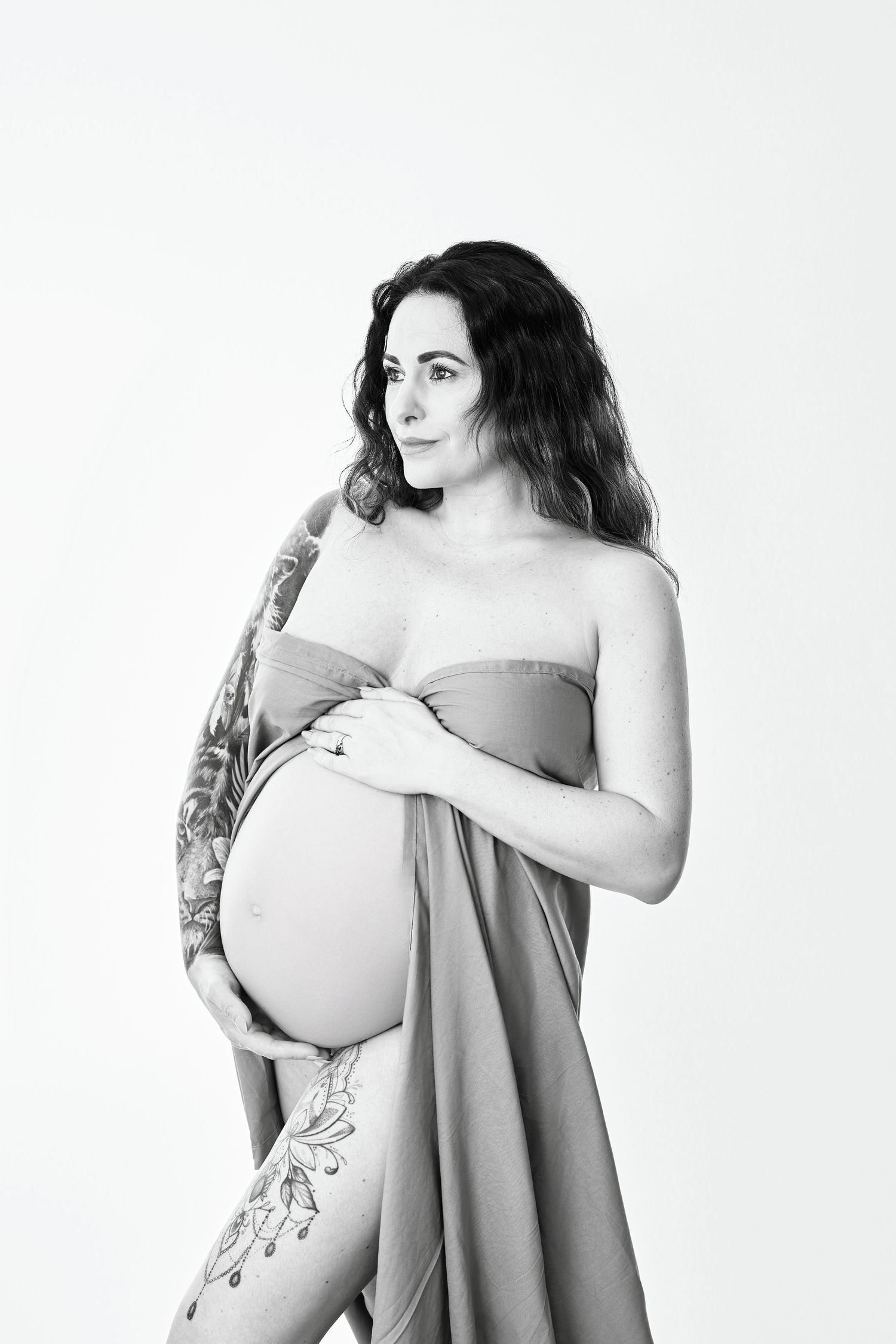 Sensual image of a mother to be near Gloucester. Black and white image with the woman wrapped in a sheet, feeling great.
