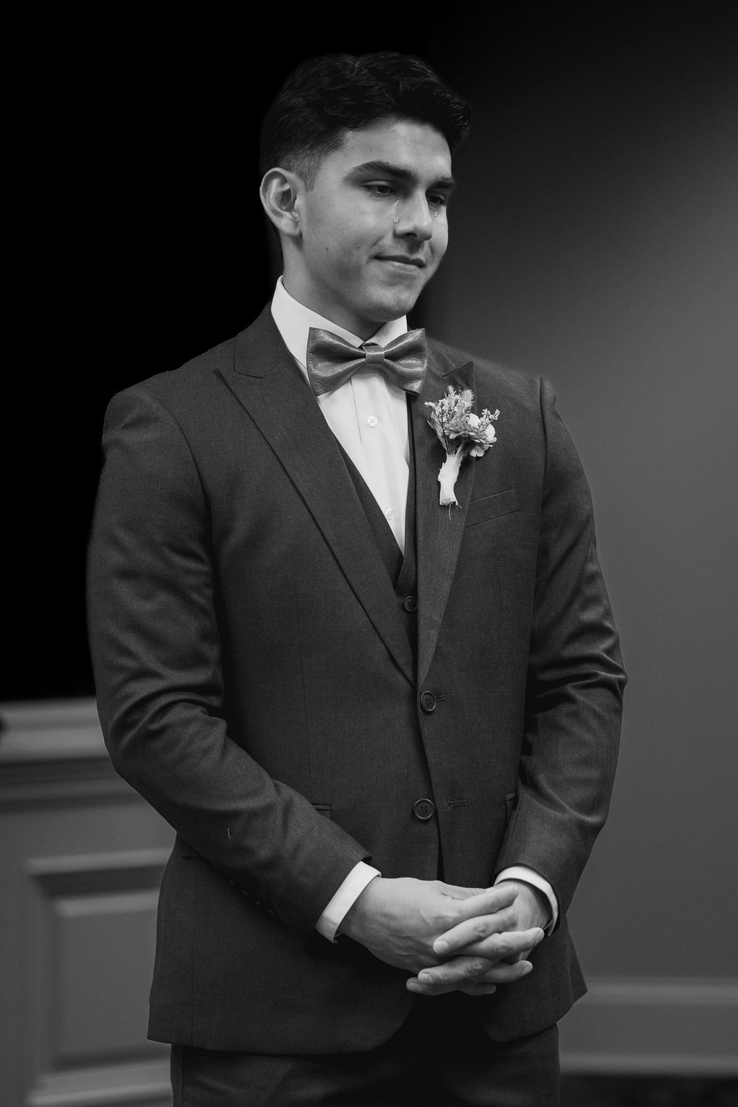 A series of black and white photos showing a groom in a formal dark suit and bowtie at a wedding ceremony. South Carolina Wedding Photograph