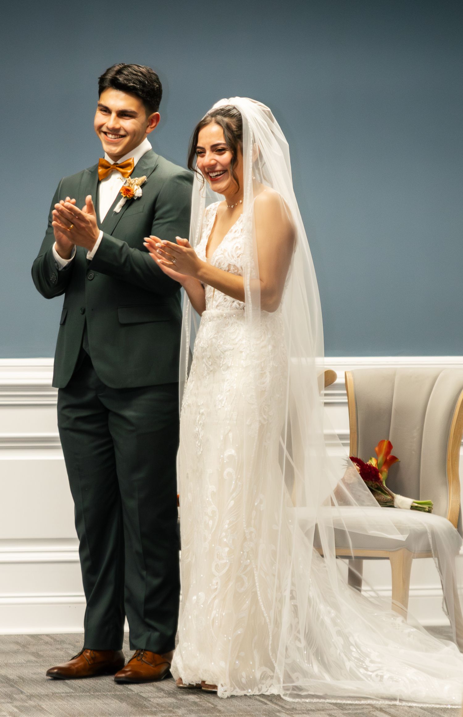 A couple in formal wedding attire share a lighthearted moment during their ceremony. South Carolina Wedding Photographer