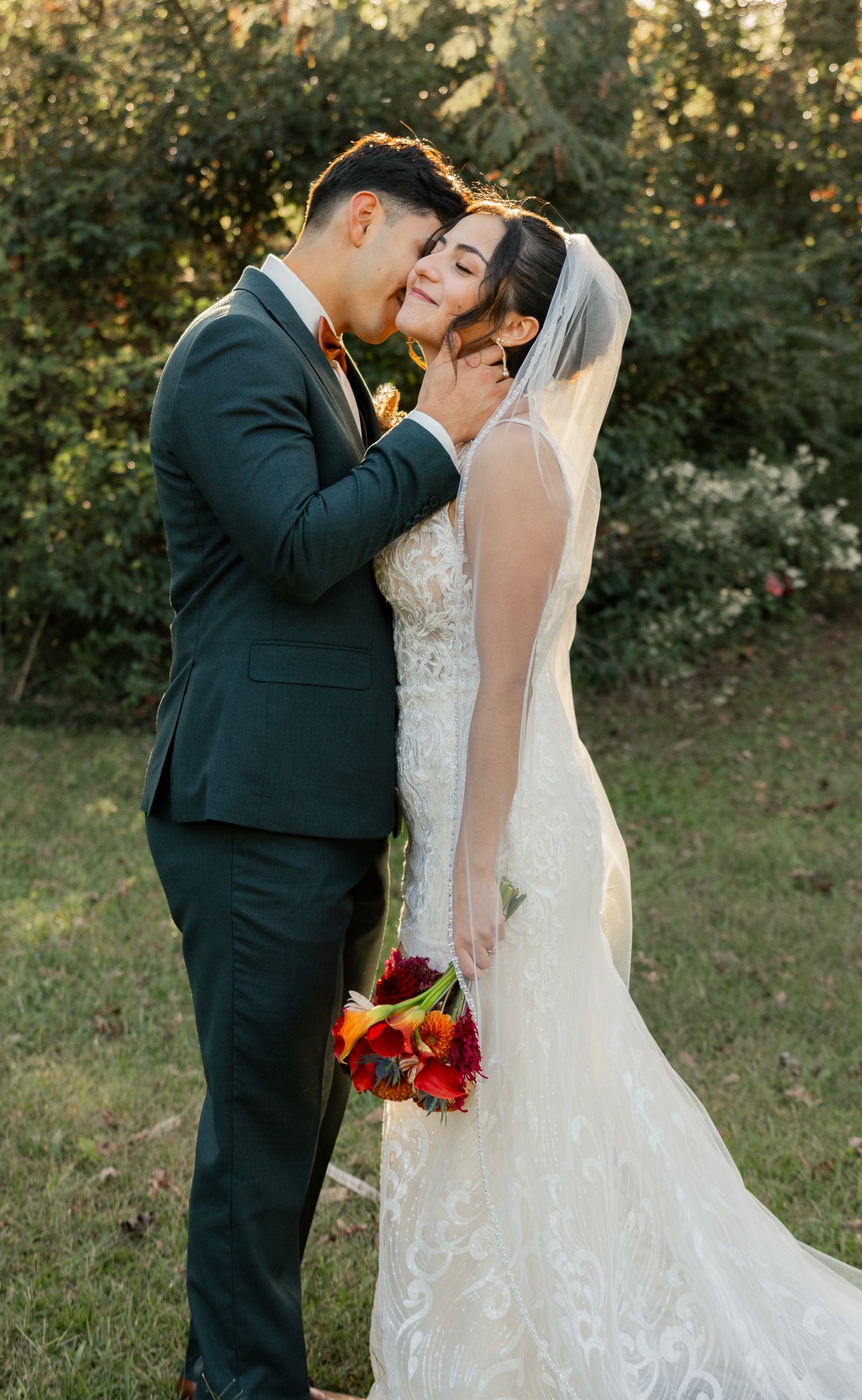 A romantic wedding couple shares intimate moments in a garden setting during golden hour. South Carolina Wedding Photographer