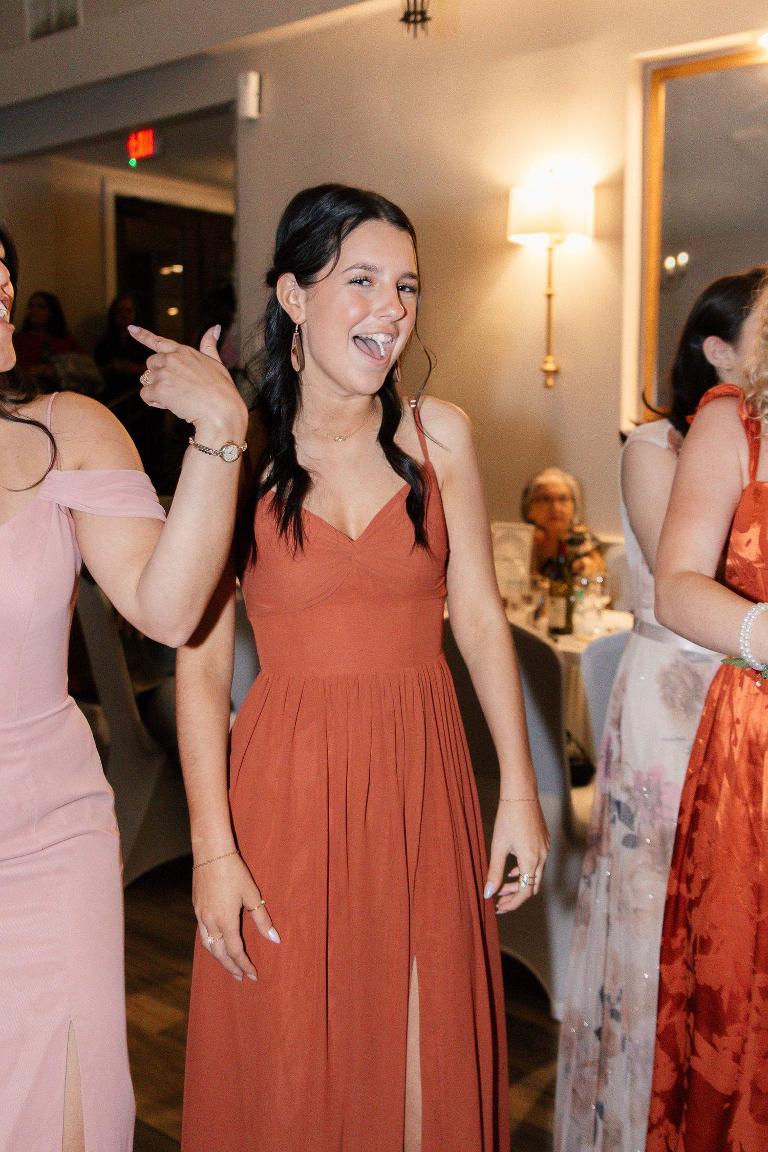 Wedding party guests dancing and celebrating in formal attire at an indoor reception venue. Lexington Wedding Photographer