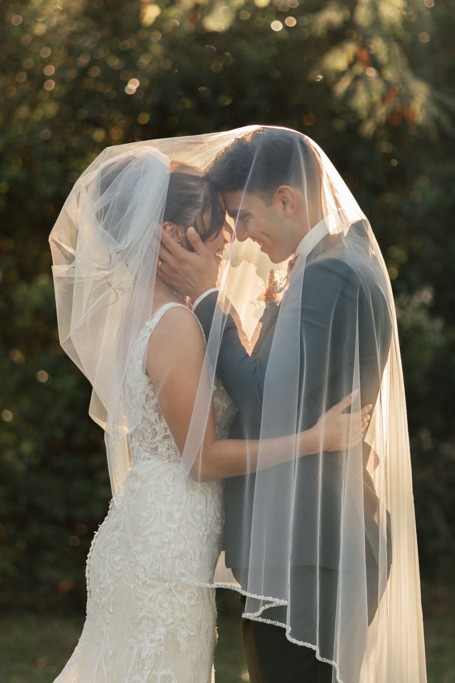 Bride and groom sharing an intimate moment beneath a veil at their Lexington, South Carolina wedding.