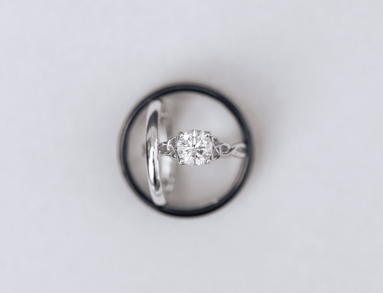 Close-up of a diamond engagement ring resting inside a wedding band.
