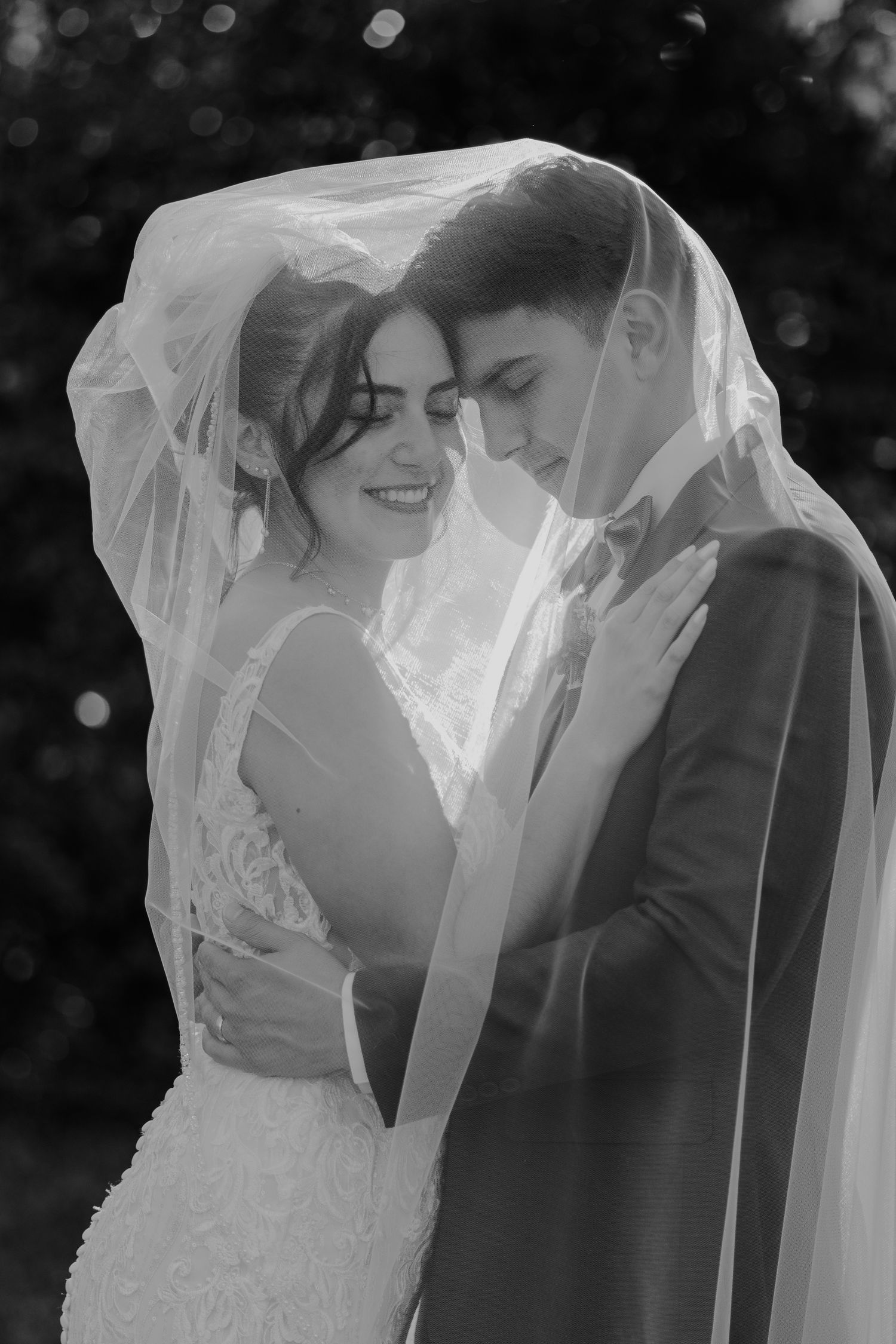 Black and white wedding portraits showing tender moments between newlyweds under a delicate veil. South Carolina Wedding Photographer