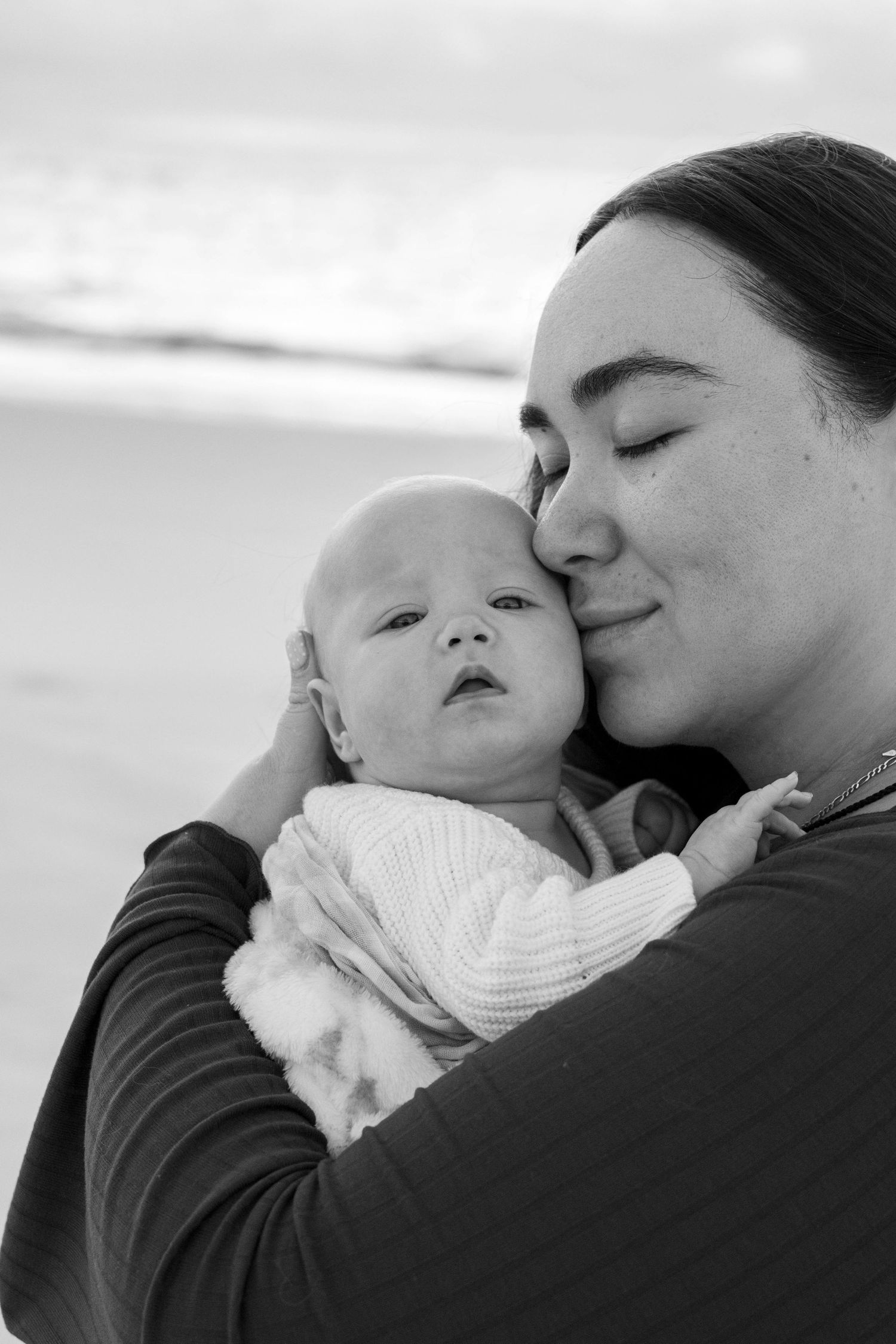 Parents cradling newborn baby during Brisbane family photography session