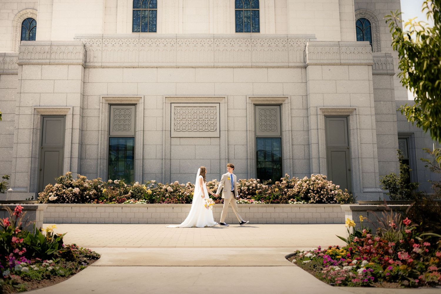 Bride and groom walking together with natural light before the ceremony.