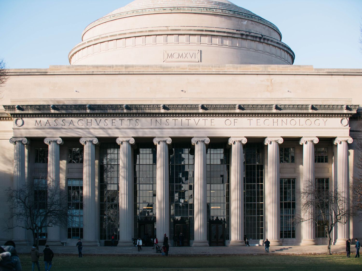 Iconic neoclassical facade of the Massachusetts Institute of Technology building with large dome.