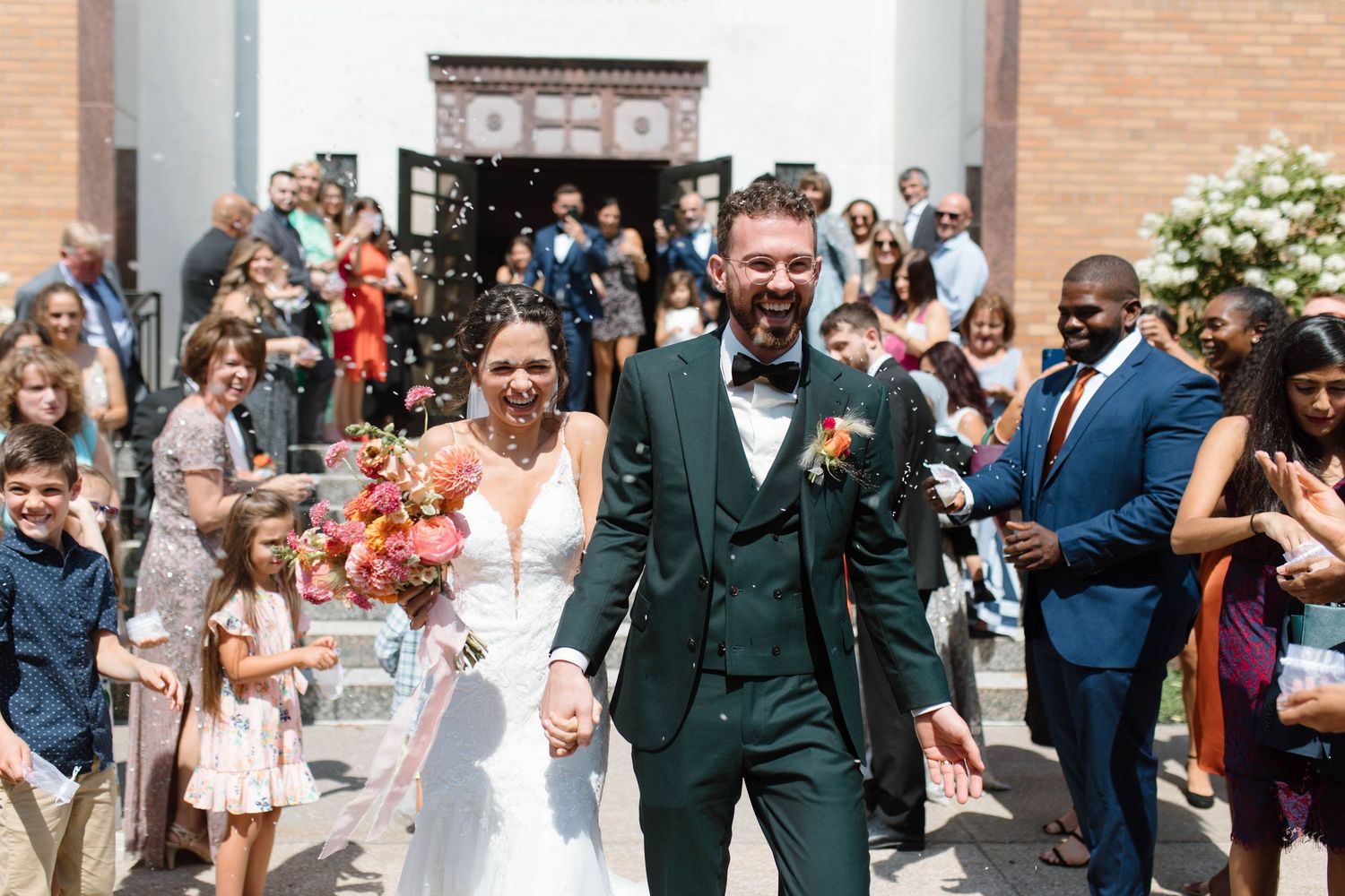 Wedding party members celebrate and dance together in a joyful line during the reception festivities.