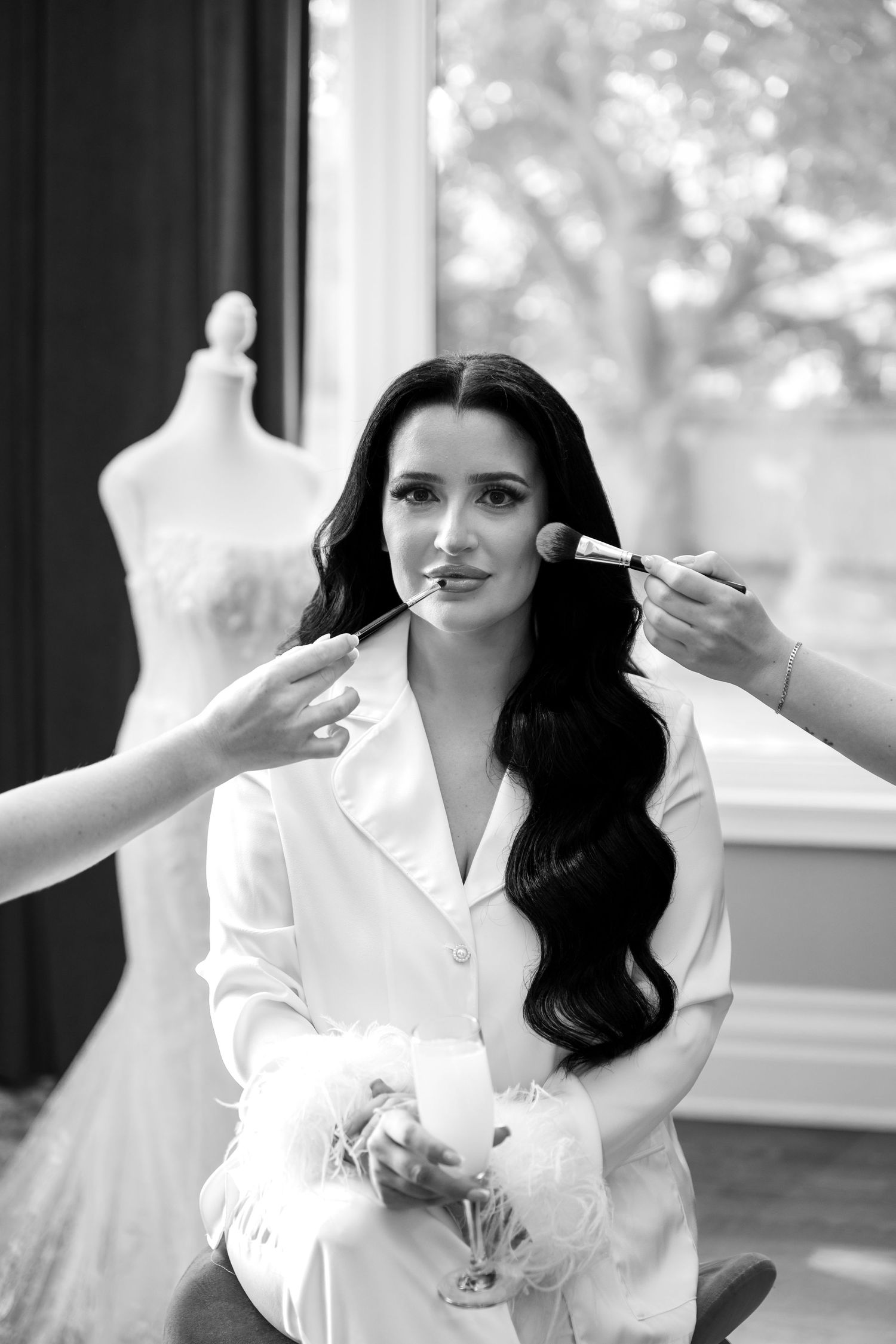 Black and white photo series showing a person in white clothing making elegant poses with dramatic lighting and shadows.