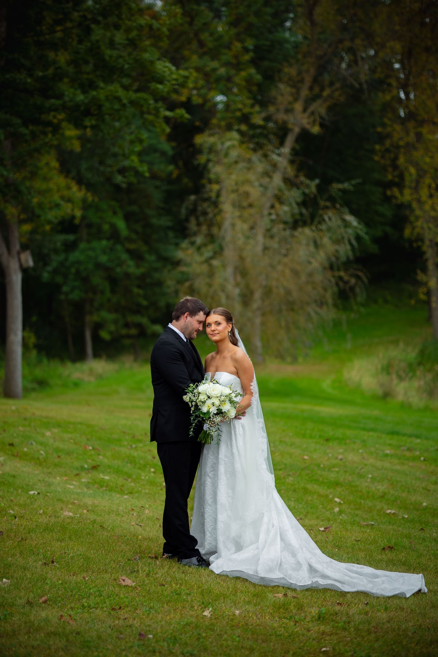 Bemidji Couple who is getting married smiles for photos taken by a Bemidji wedding photographer