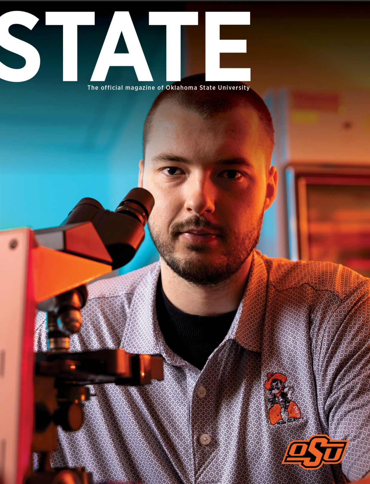 OSU student examines microscope in lab wearing Oklahoma State University branded shirt on STATE magazine cover.