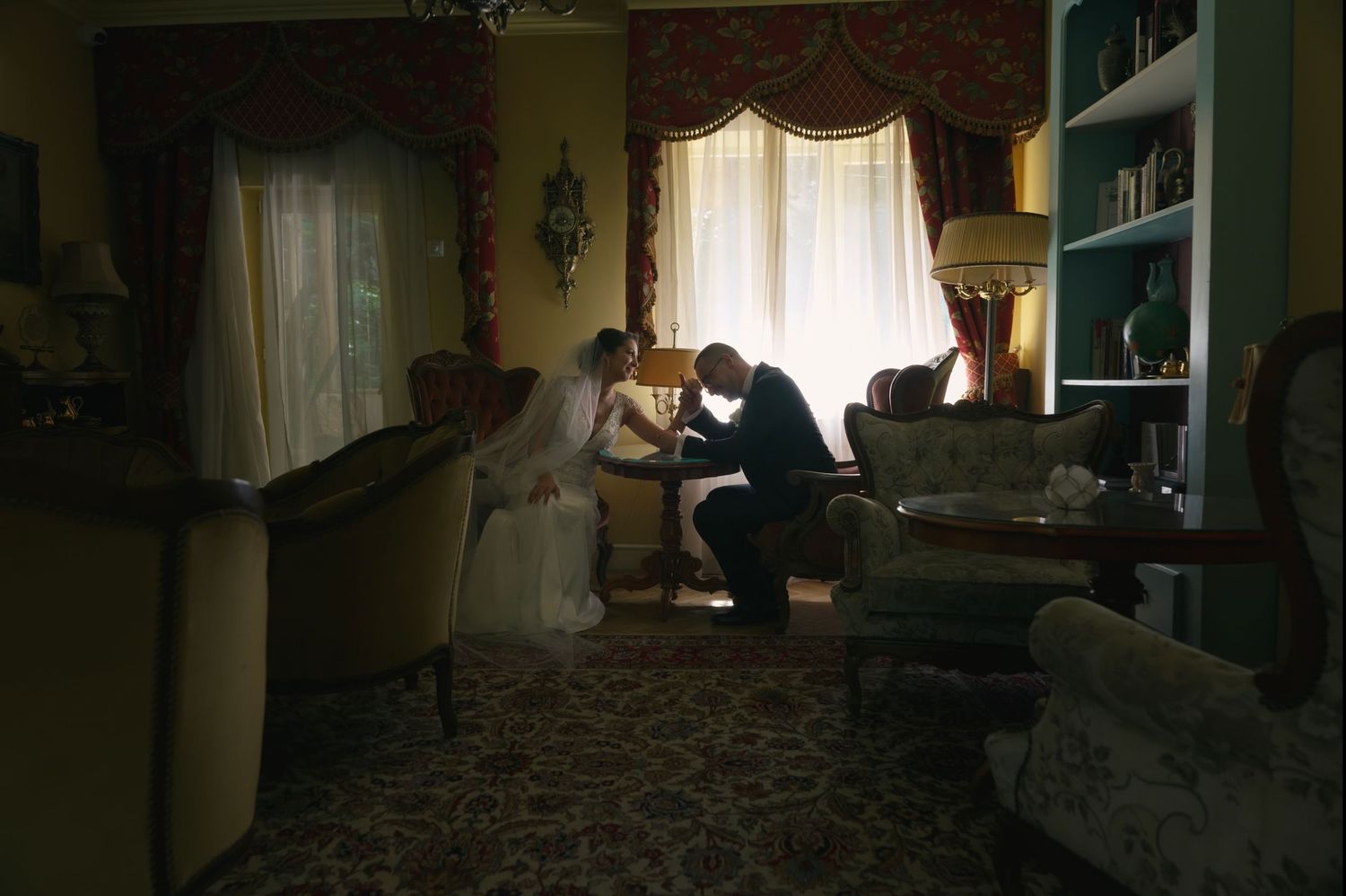 Capture a romantic moment of the bride and groom in an intimate room, creating a beautiful and private wedding memory.