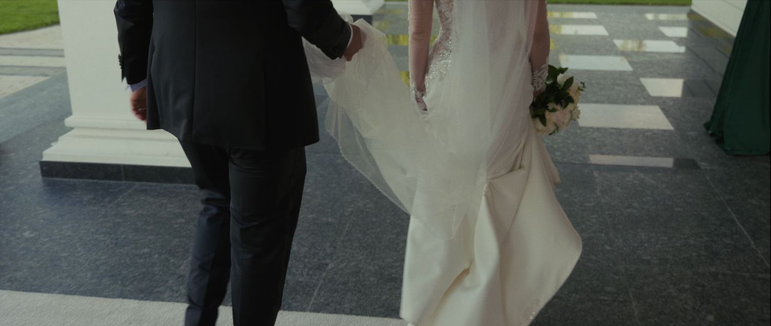 Capture the elegance and love of the bride and groom walking together, showcasing a beautiful and timeless moment from your wedding day.
