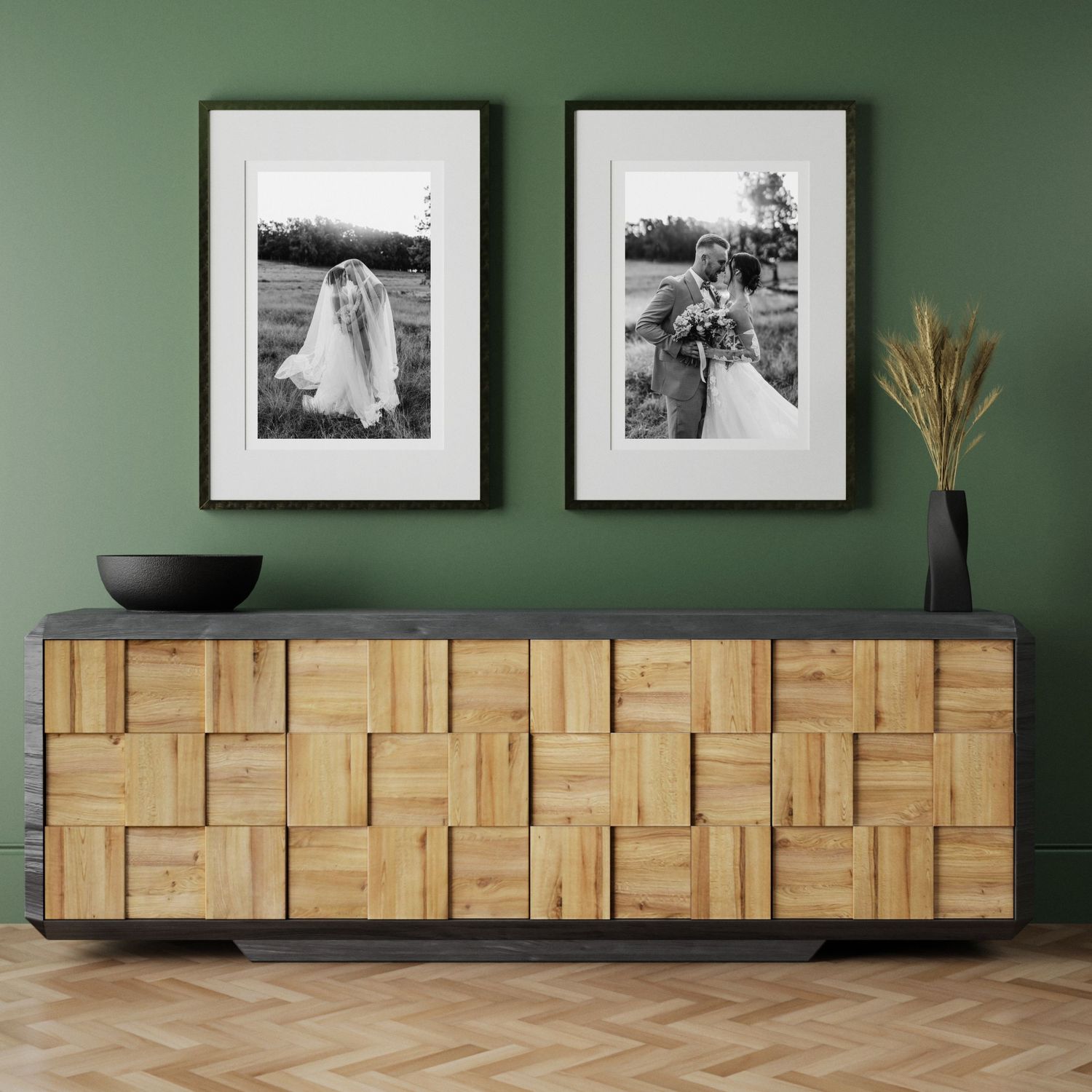 Minimalist wall display featuring black and white family photographs in simple frames.
