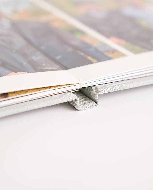 Neutral linen layflat photo album covers shown as cover options.