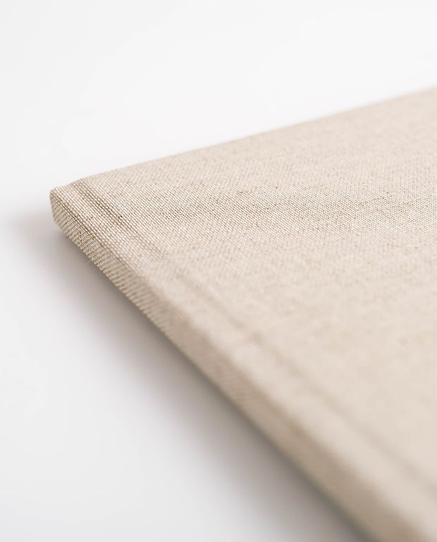 Close up of a wheat coloured linen photo album cover.