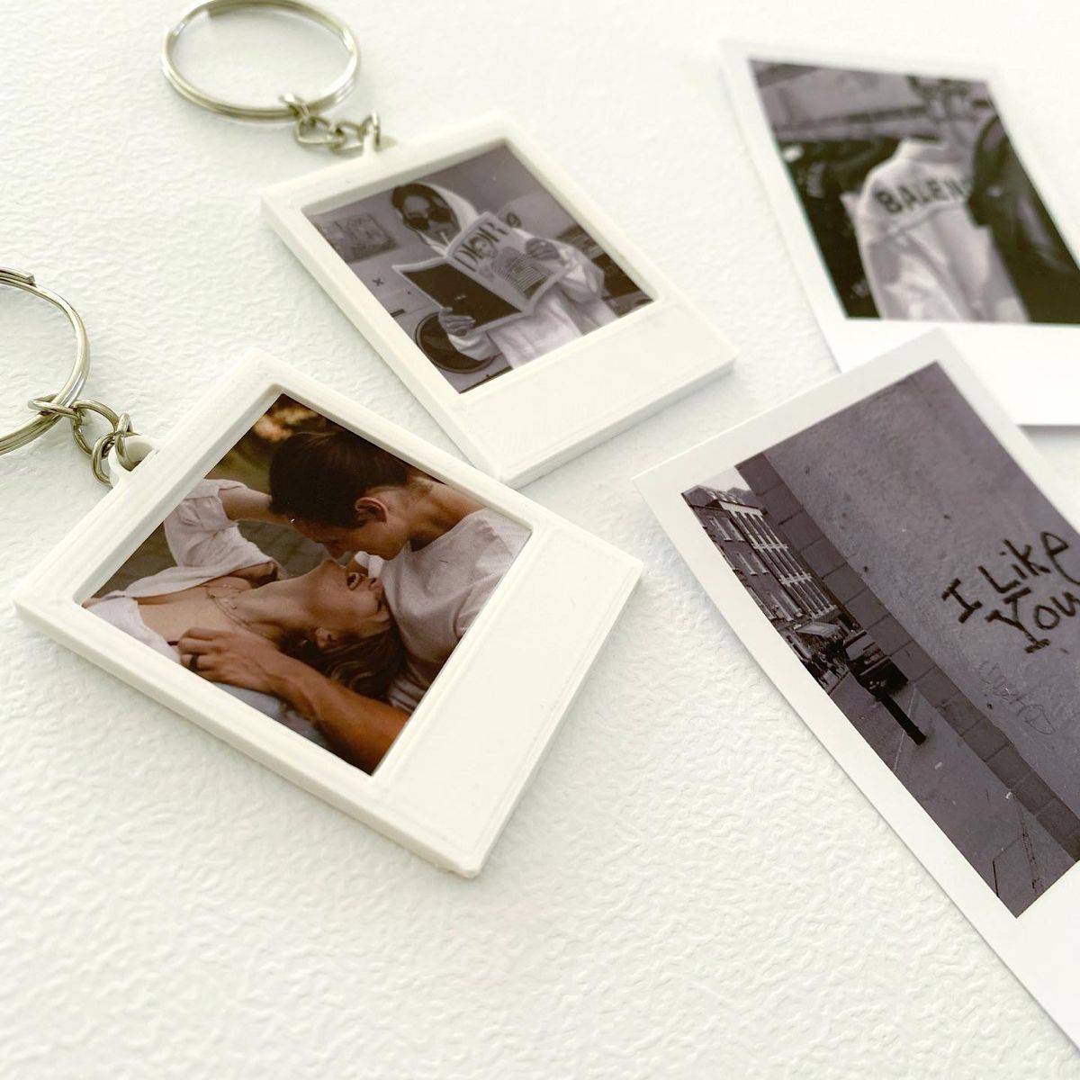 A flat lay of printed photographs and a photo book, illustrating creative ways to use and display professional photos.