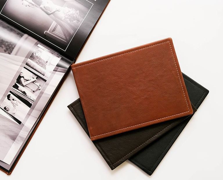 Genuine leather photo album in tan with additional leather cover options underneath