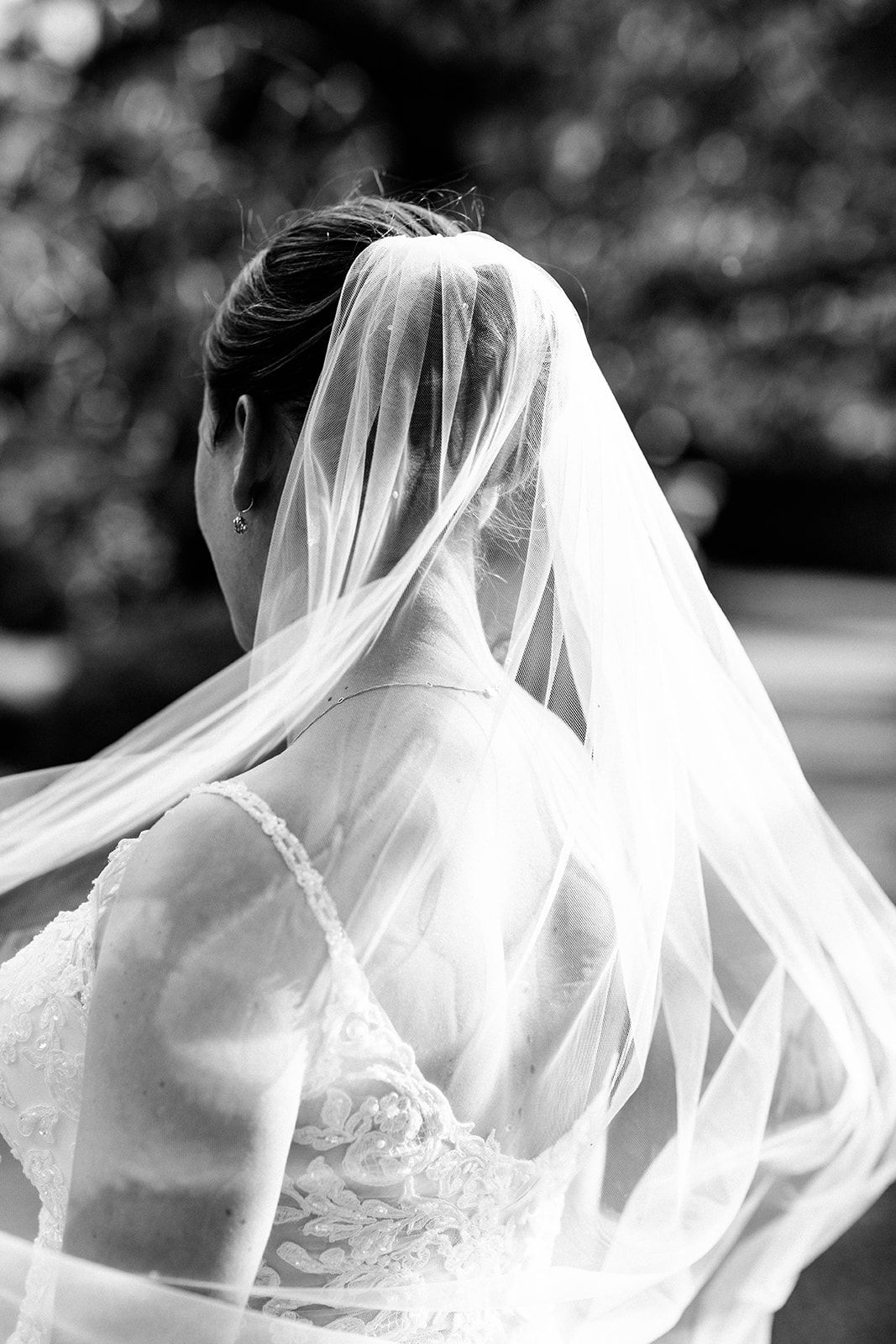 Black and white artistic sequence showing flowing bridal veil details in elegant wedding photography.