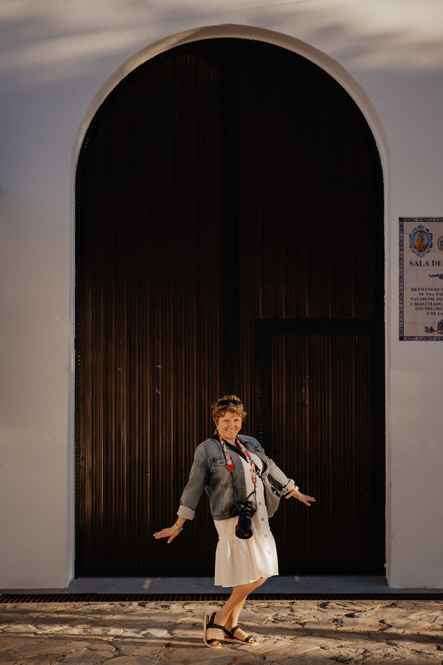 A sequence of photos showing a person dancing and moving expressively against a white wall with dark arched doorways.