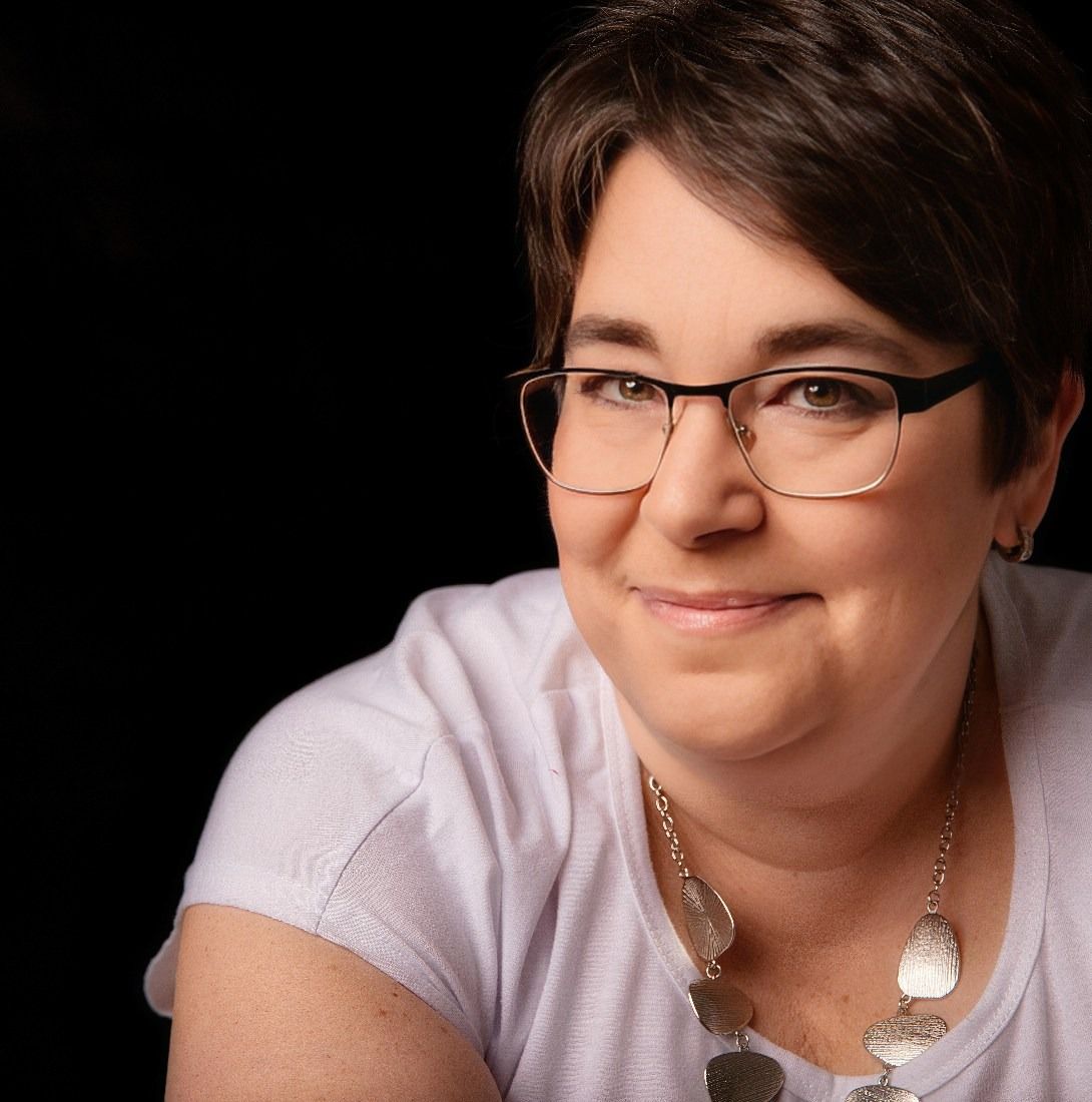 Person in white shirt smiling warmly against black background in series of candid portrait shots.