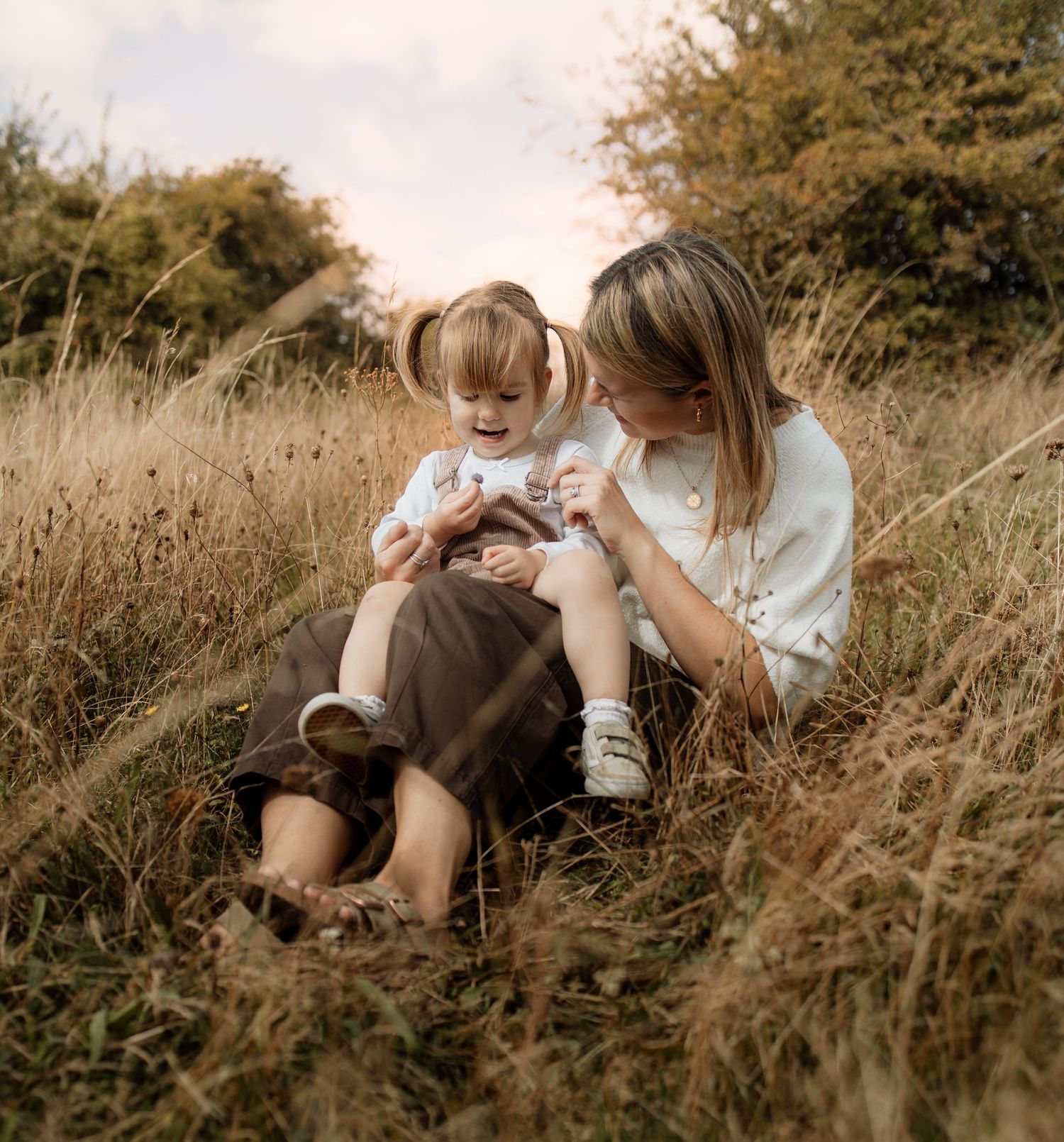 Mum cuddling her child during an outdoor family photography session near Winchester