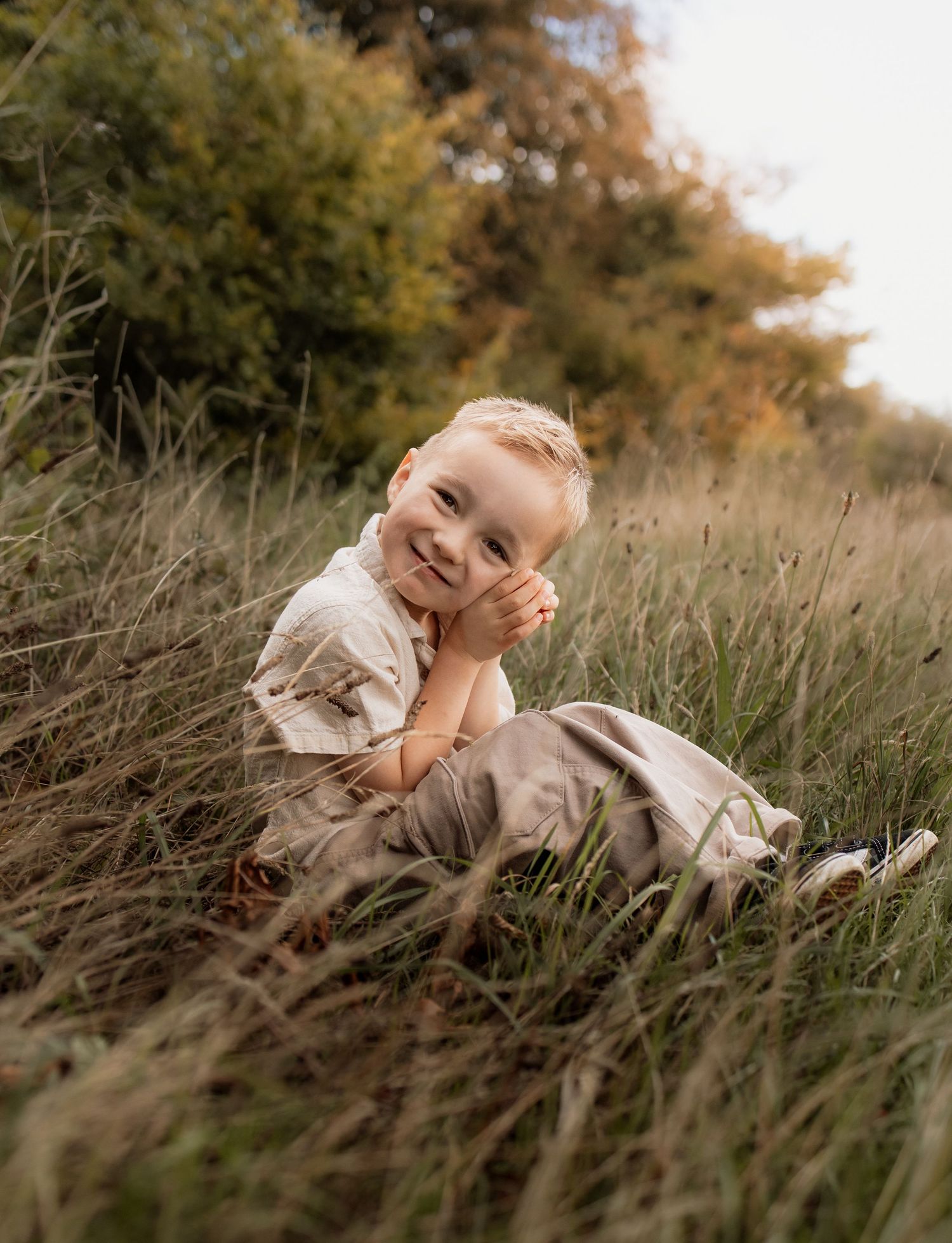 Little boy sitting and smiling during a natural family photography session in Winchester
