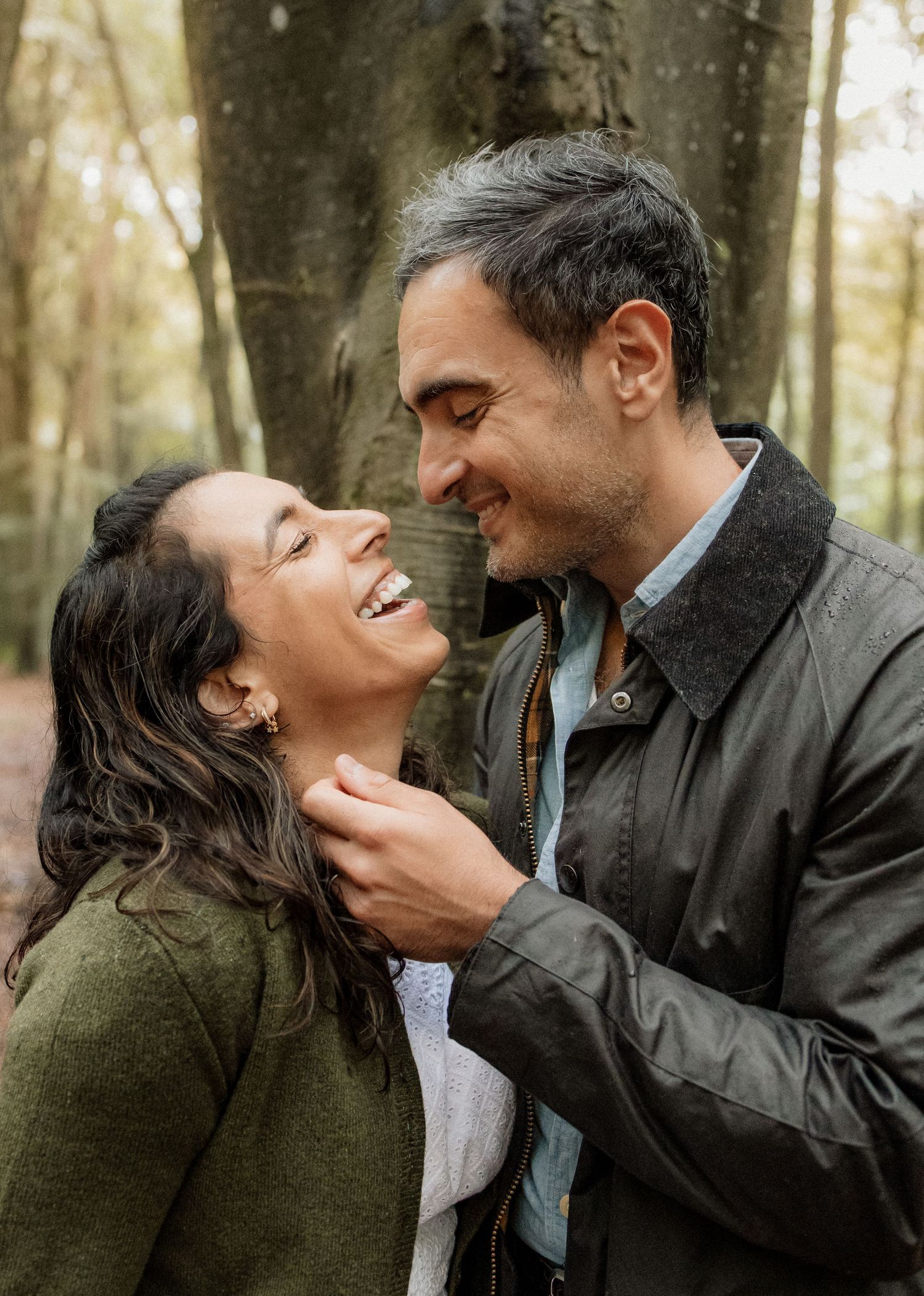 Mum and Dad laughing together during their Micheldever Woods family photoshoot