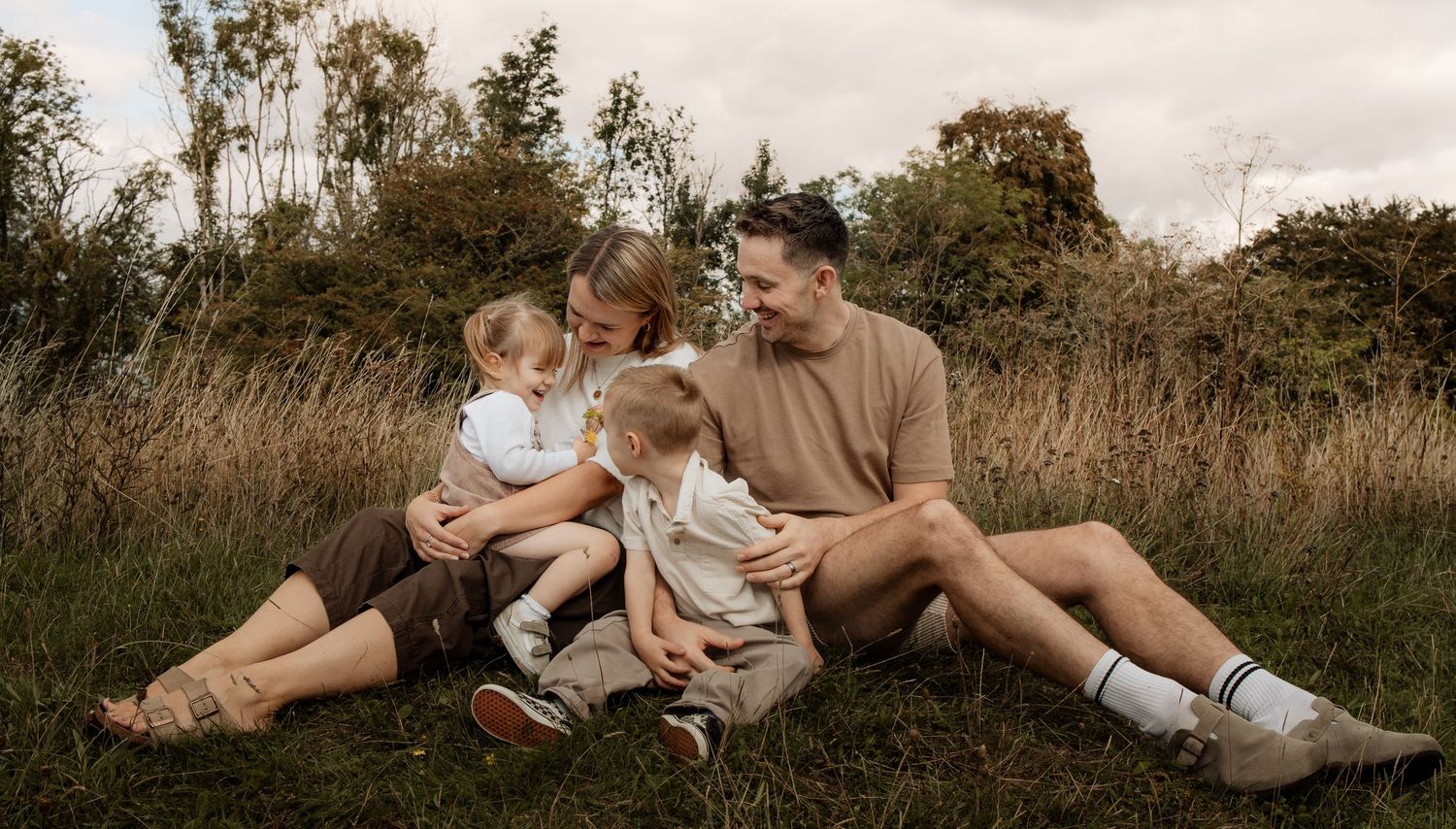 Family sharing a cuddle during a natural outdoor photography session in Winchester