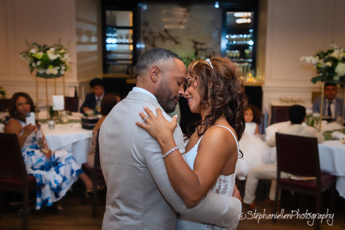 Newlyweds sharing an intimate first dance at their wedding reception.