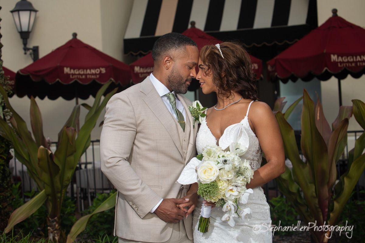 Bride and groom share a romantic moment outside Maggianos restaurant on their wedding day.