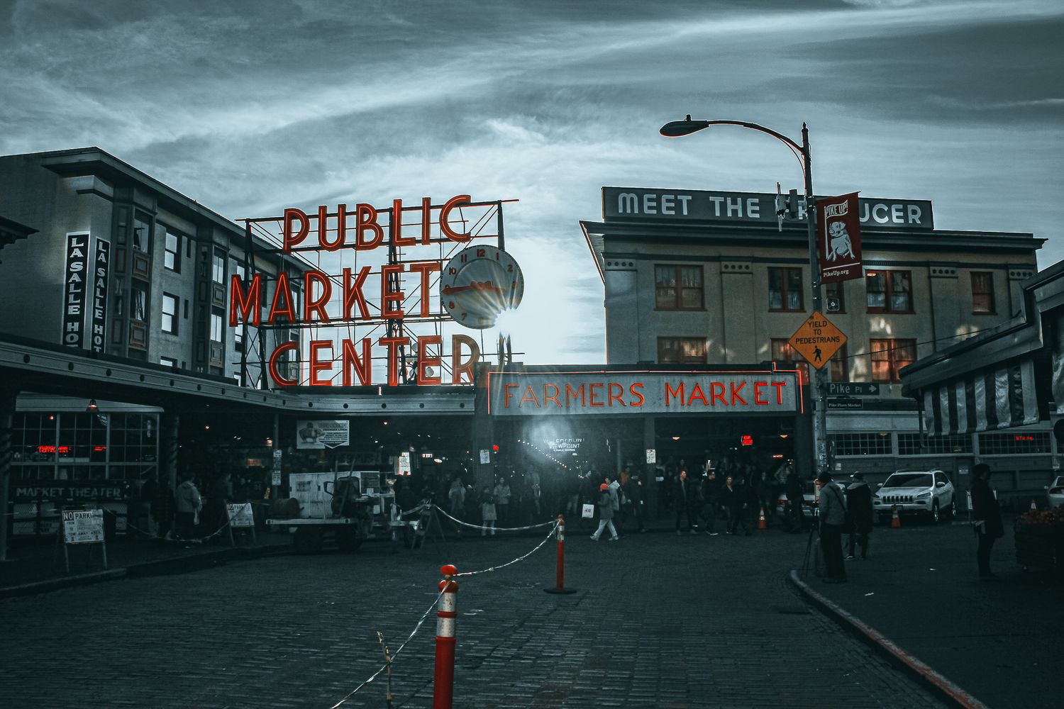 Pike Place Public Market Center sign illuminated at dusk in Seattle, Washington.
