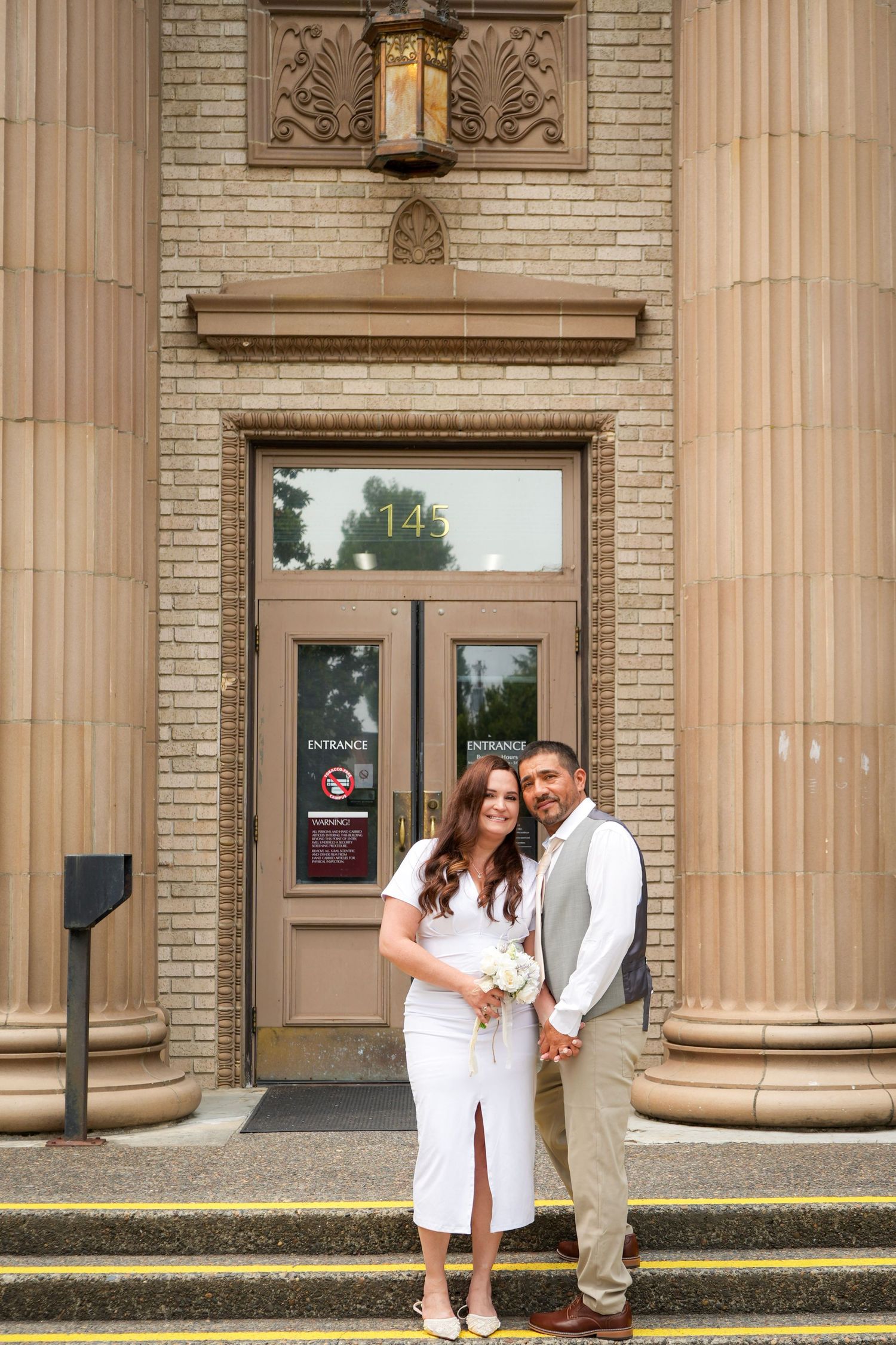 Bride and groom embracing on the steps of the Washington County Courthouse.