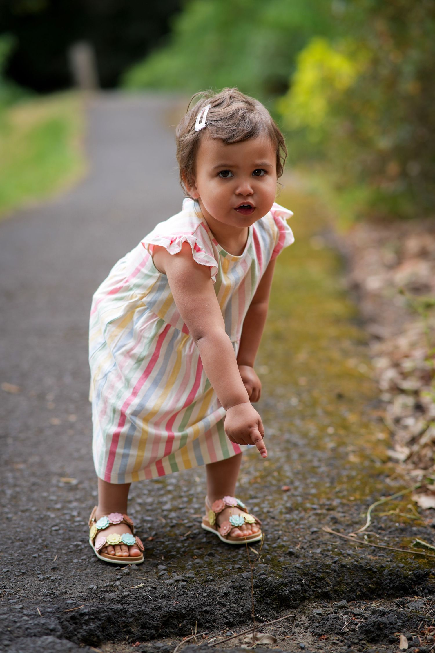 Toddler girl exploring a wooded path during a candid outdoor child photography session in Oregon