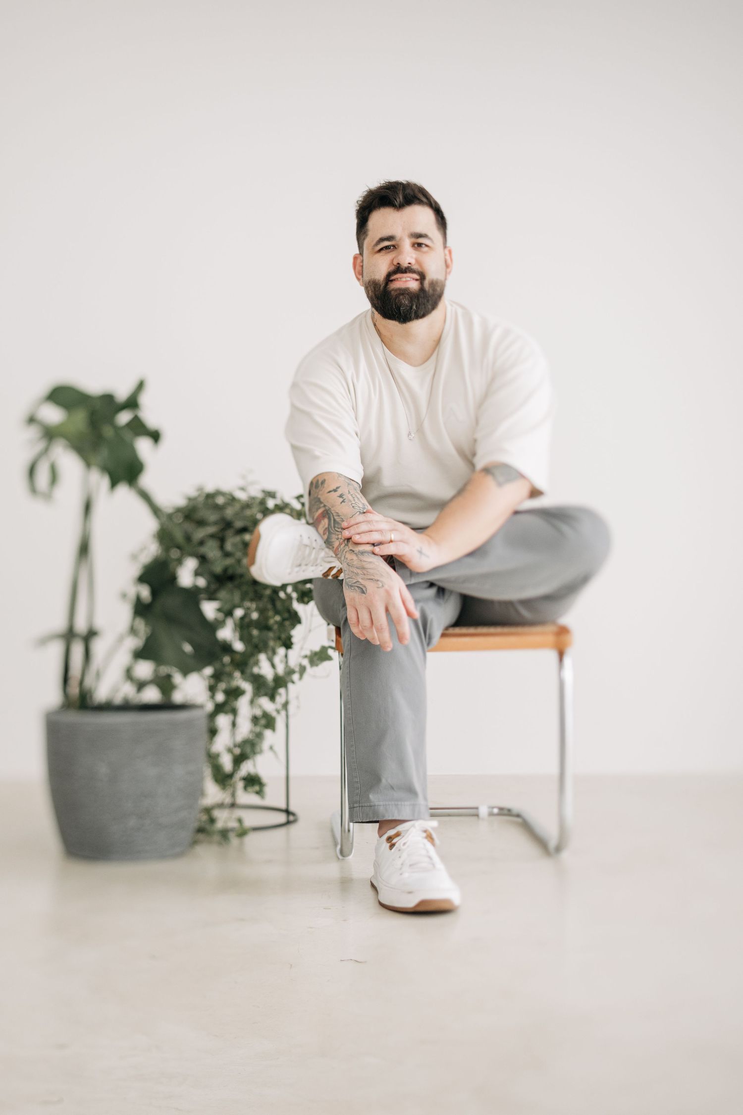 Minimalist indoor portraits with potted plants and white decor.